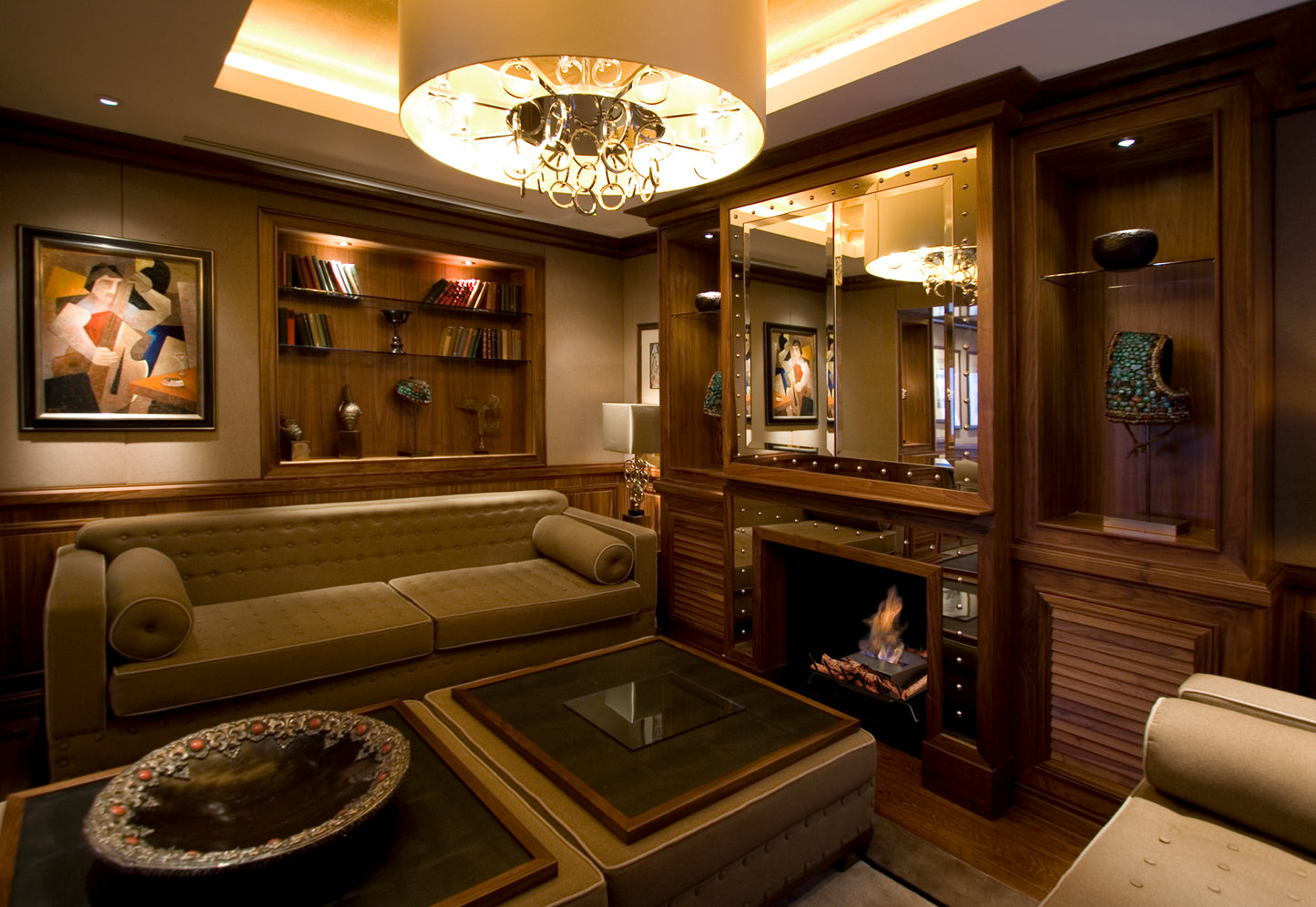 Luxurious living room with beige sofa, coffee table, and decorative items.