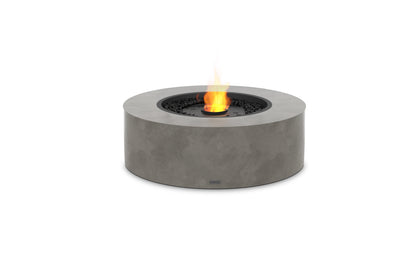 Round concrete fire pit with flames on a white background