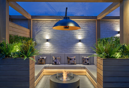 Outdoor patio with seating area, fire pit, and decorative lighting
