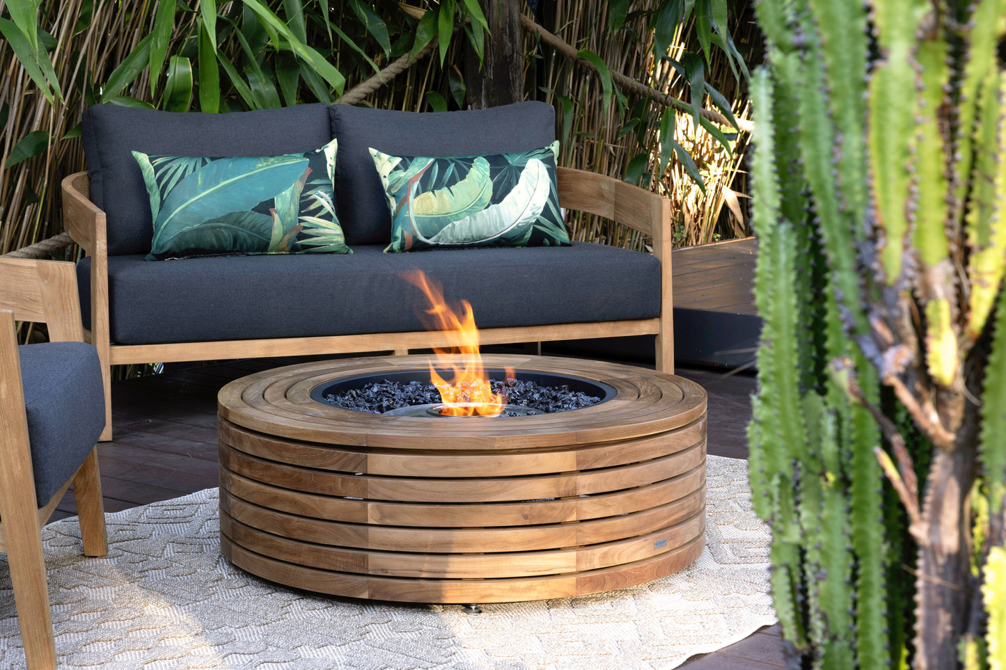 Outdoor seating area with a fire pit surrounded by plants