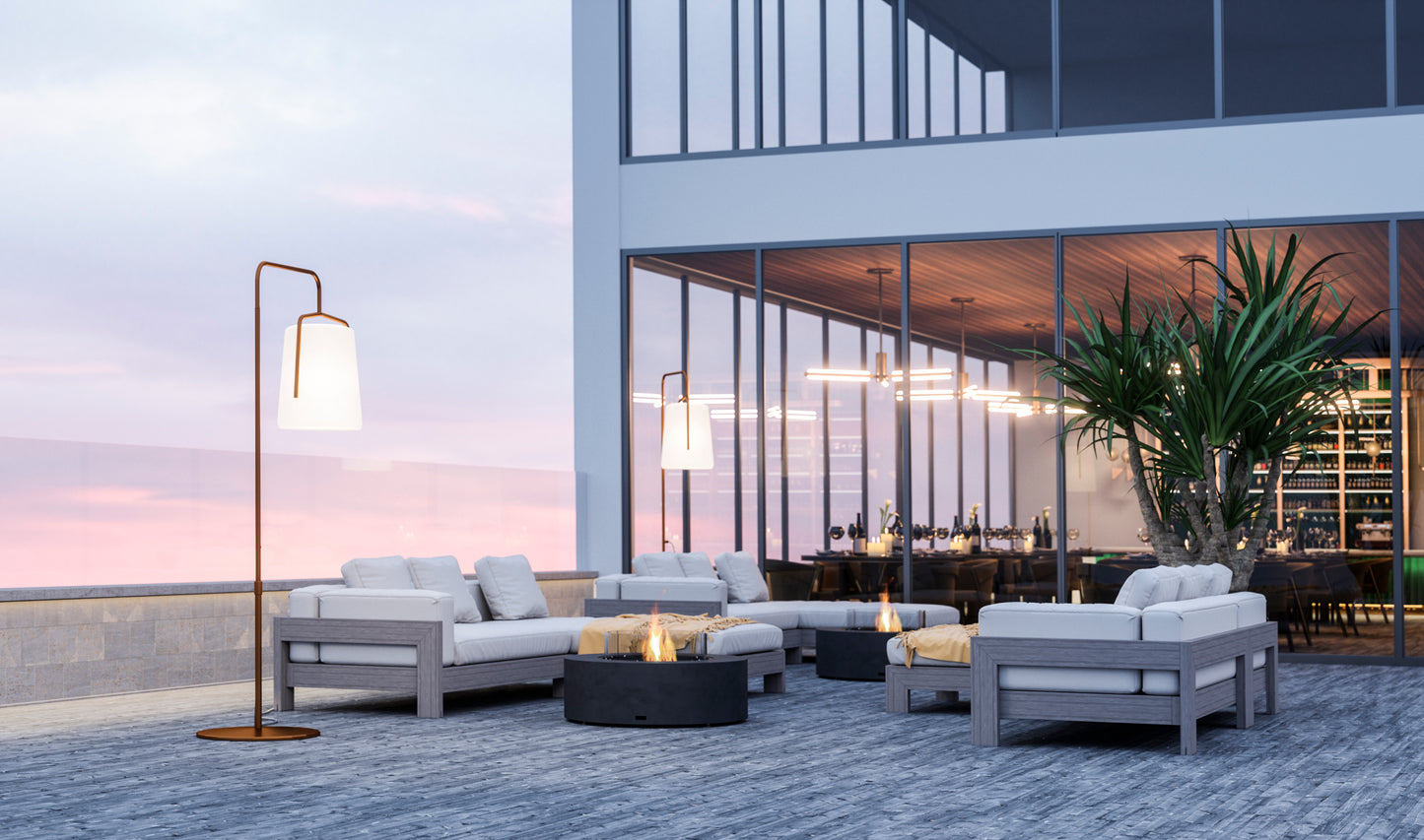 Outdoor patio area with modern furniture and a building in the background