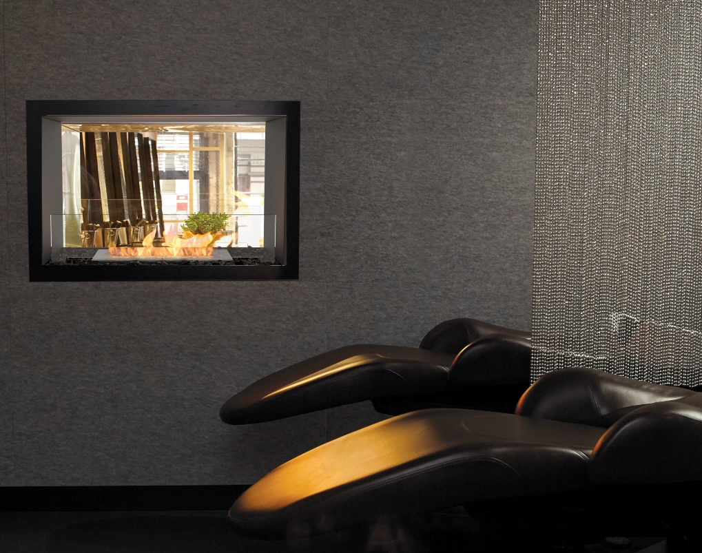Modern living room with a wall-mounted mirror reflecting a window view.
