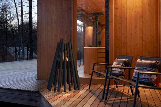 Wooden deck with chairs and firewood, evening setting