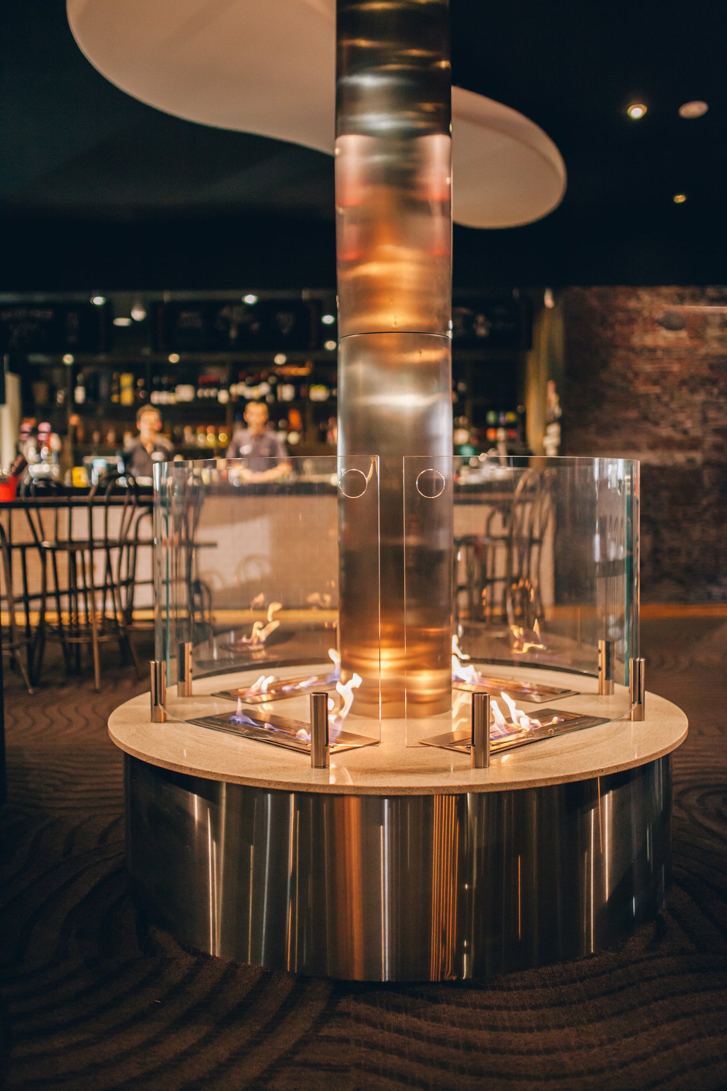 Modern indoor fire pit with glass design in a restaurant setting