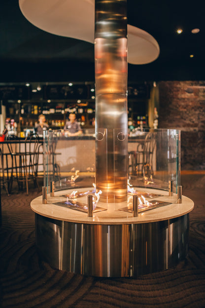 Modern indoor fire pit with glass design in a restaurant setting