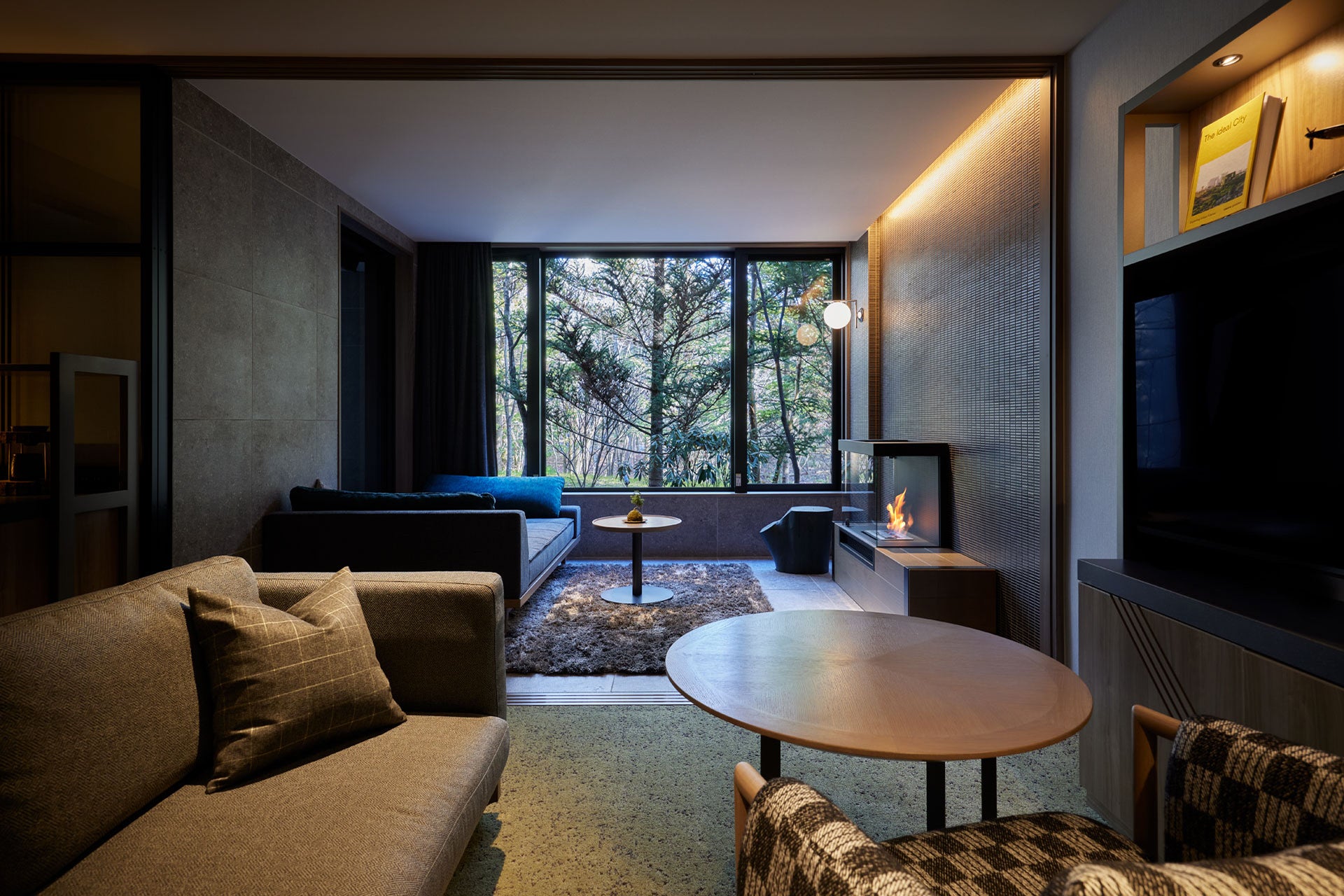 Modern living room with a large window, sofa, and coffee table.