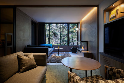 Modern living room with a large window, sofa, and coffee table.