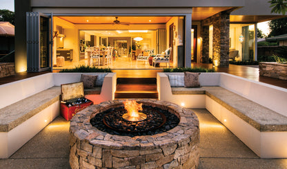 Modern outdoor living space with a fire pit and seating area.