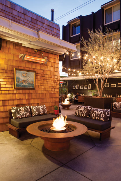 Outdoor patio with fire pit, seating area, and string lights.