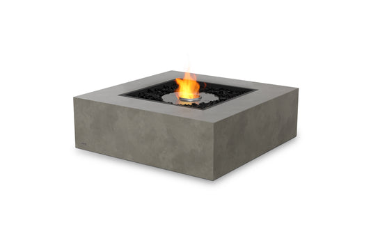 Square concrete fire pit table with flames on a white background