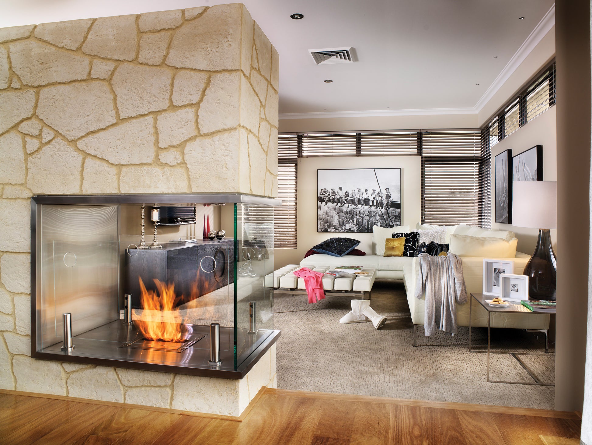 Modern living room with a stone fireplace and stylish decor.
