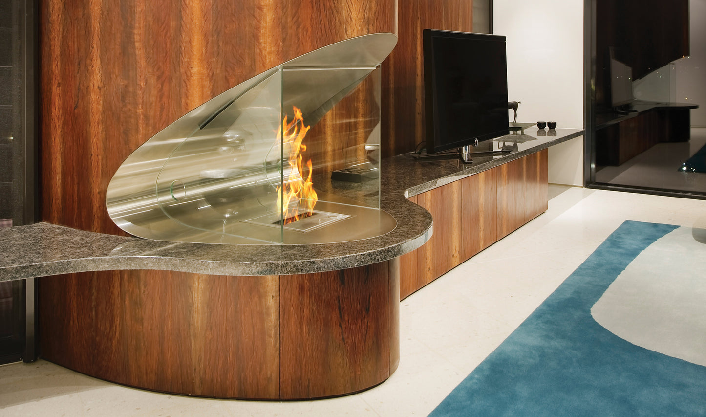 Modern fireplace with glass front in a living room setting