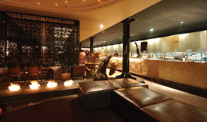 Interior of a bar with leather booths and decorative lighting
