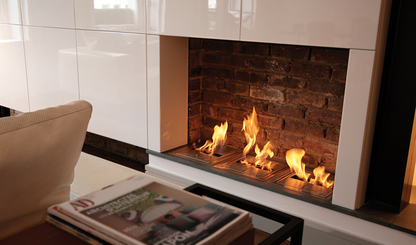 Modern fireplace with flames inside a white frame, surrounded by a cozy living room setting.