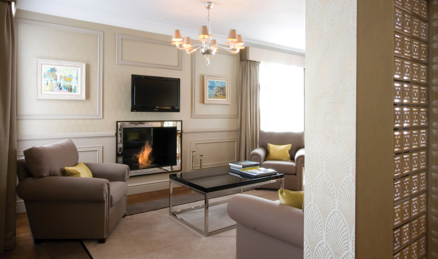 Living room with fireplace, sofa, and coffee table in a stylishly decorated room.