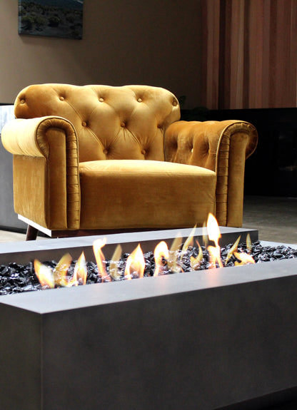 Gold armchair in front of a fire pit with flames