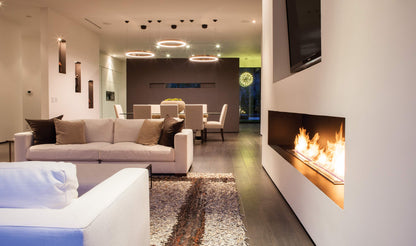 Modern living room with a fireplace, sofa, and chairs.