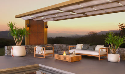 Outdoor patio with furniture and fire pit overlooking a scenic landscape.