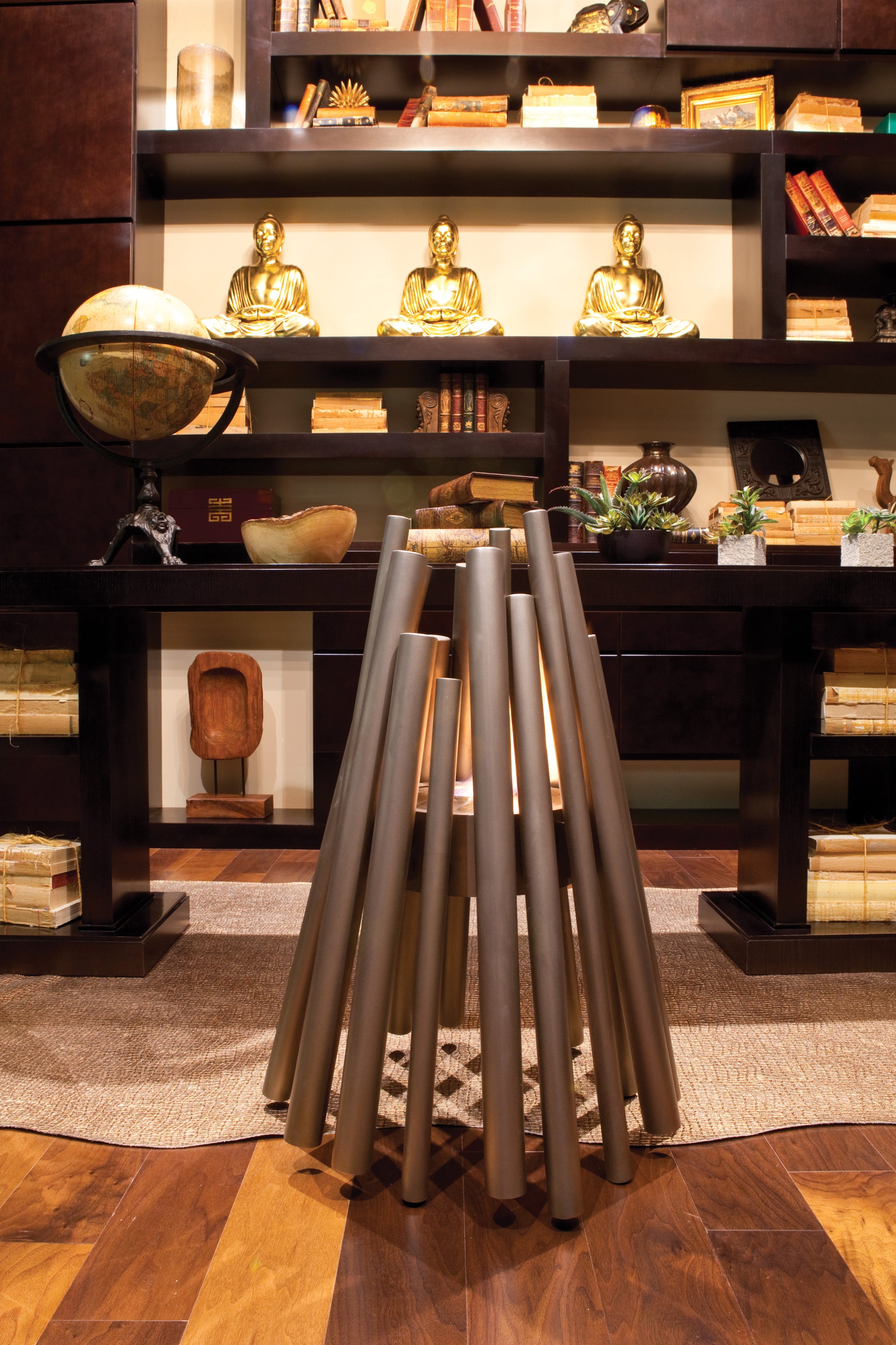 Decorative interior setting with shelves, decorative items, and a metallic stool.