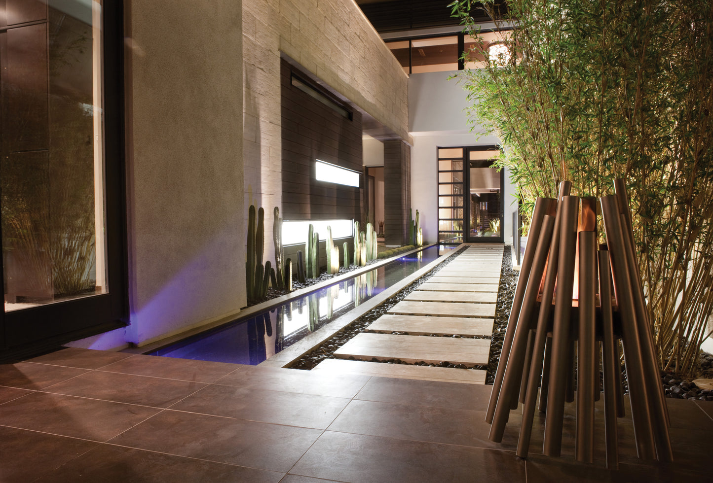 Modern indoor garden with plants and a water feature.