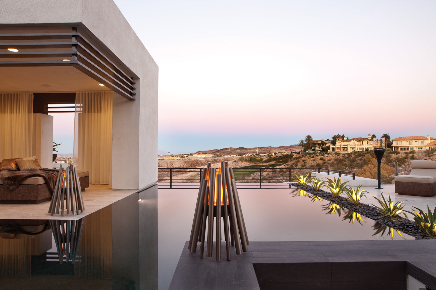 Modern outdoor setting with a pool, seating area, and scenic view.