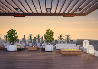Modern rooftop patio with city skyline view, seating area, and fire pit.