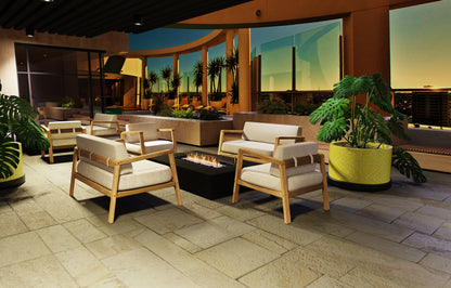 Outdoor patio area with wooden chairs, white cushions, and a fire pit.