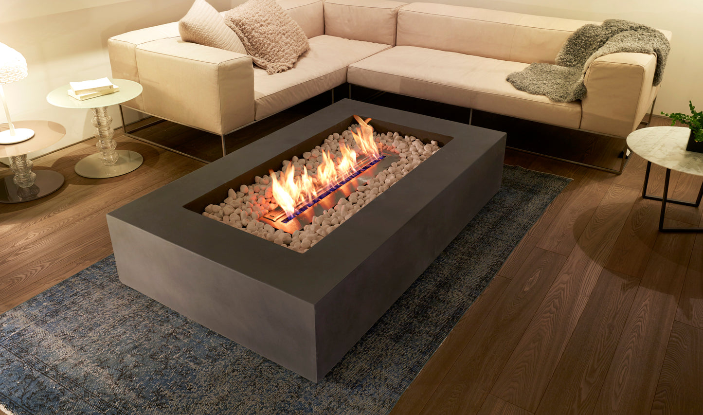 Modern fire pit table with flames in a living room setting