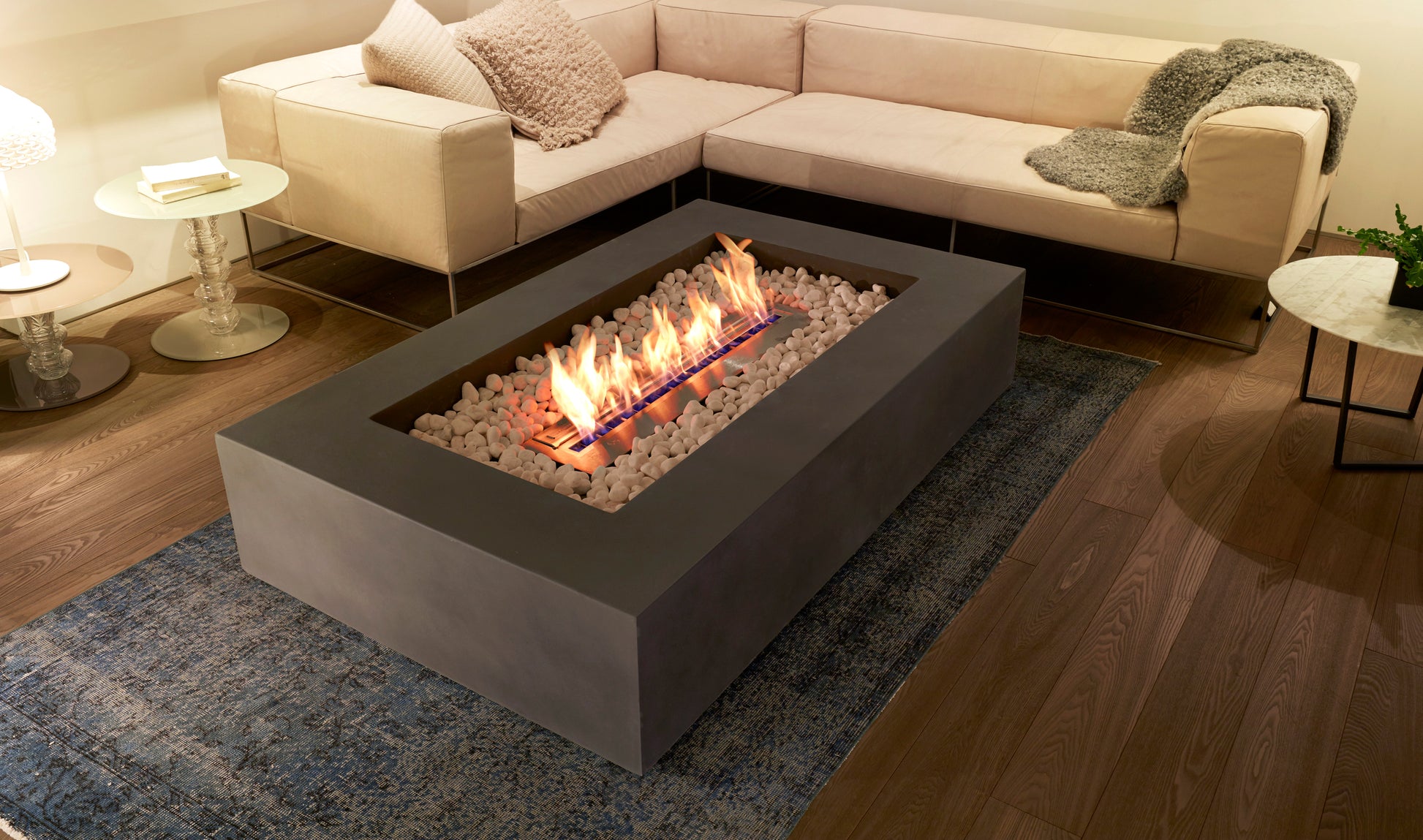 Modern fire pit table with flames in a living room setting