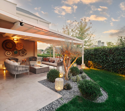 Outdoor patio area with furniture, lighting, and decorative elements on a sunny day.