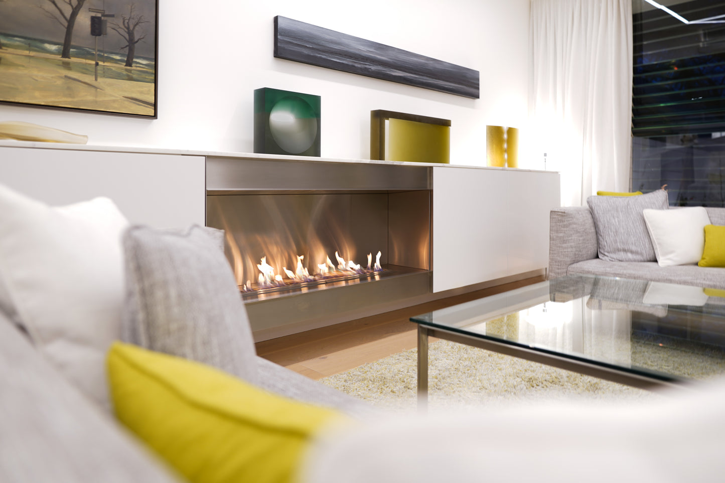 Modern living room with a fireplace and decorative elements.
