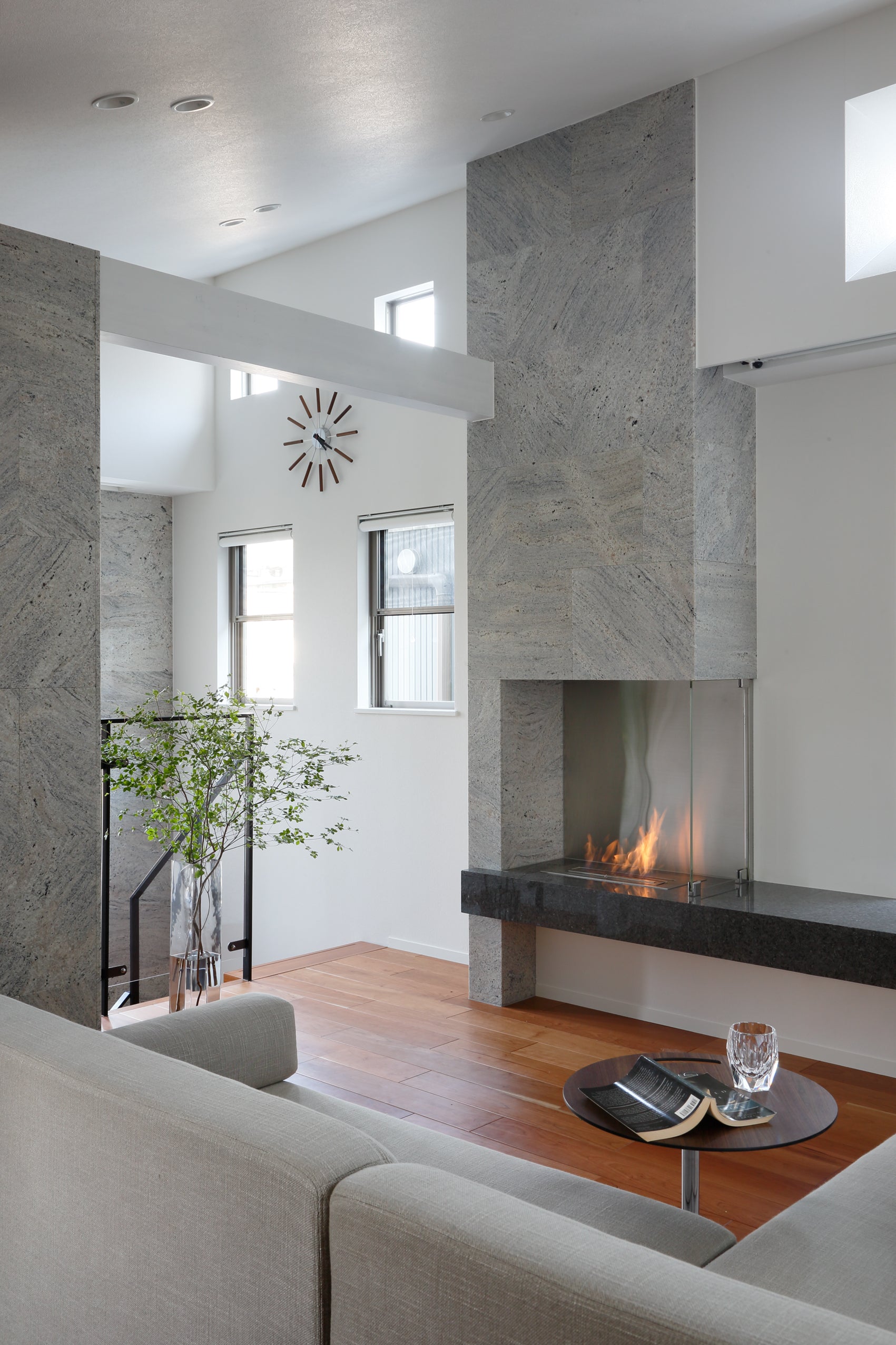 Modern living room with a fireplace, gray walls, and a white ceiling.