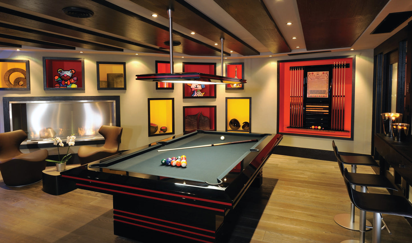 Modern billiards room with pool table, chairs, and decorative elements.