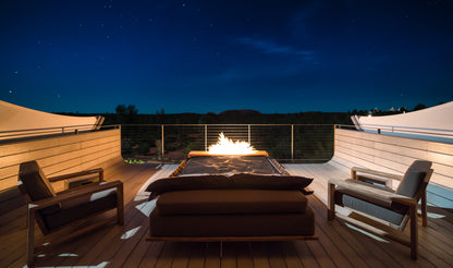 Outdoor deck with fire pit and chairs under a starry night sky