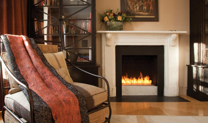 Cozy living room with a fireplace, armchair, and decorative elements.