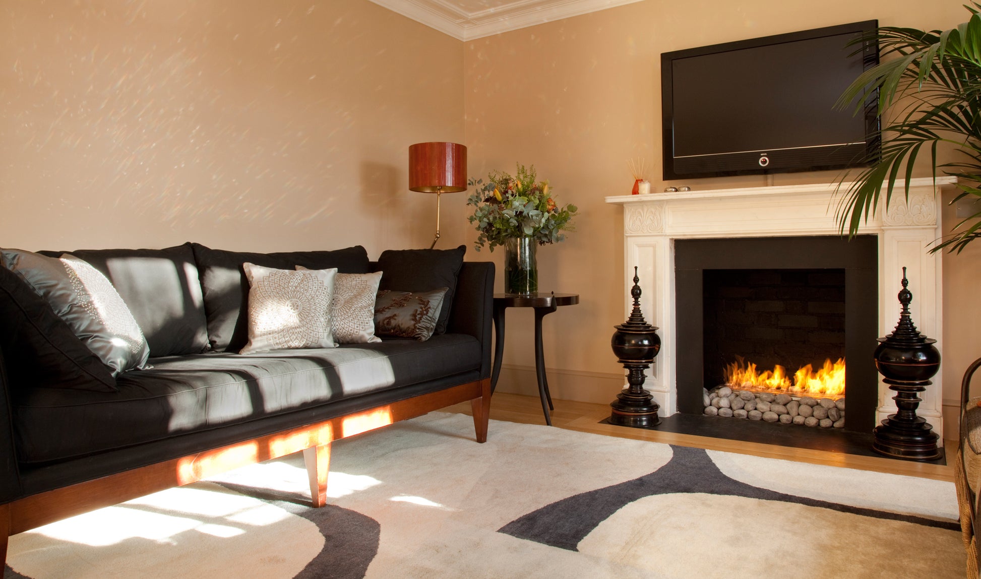 Living room with a fireplace, television, and decorative items.