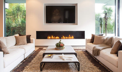 Modern living room with white sofas, a coffee table, and a fireplace.