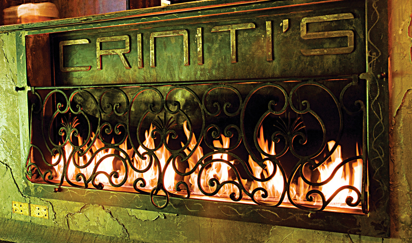 Decorative fireplace cover with 'Criniti's' branding and visible flames.