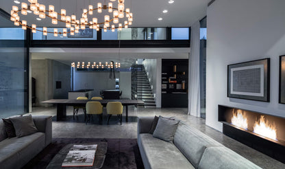 Modern living room with gray sofa, coffee table, and wall-mounted fireplace.