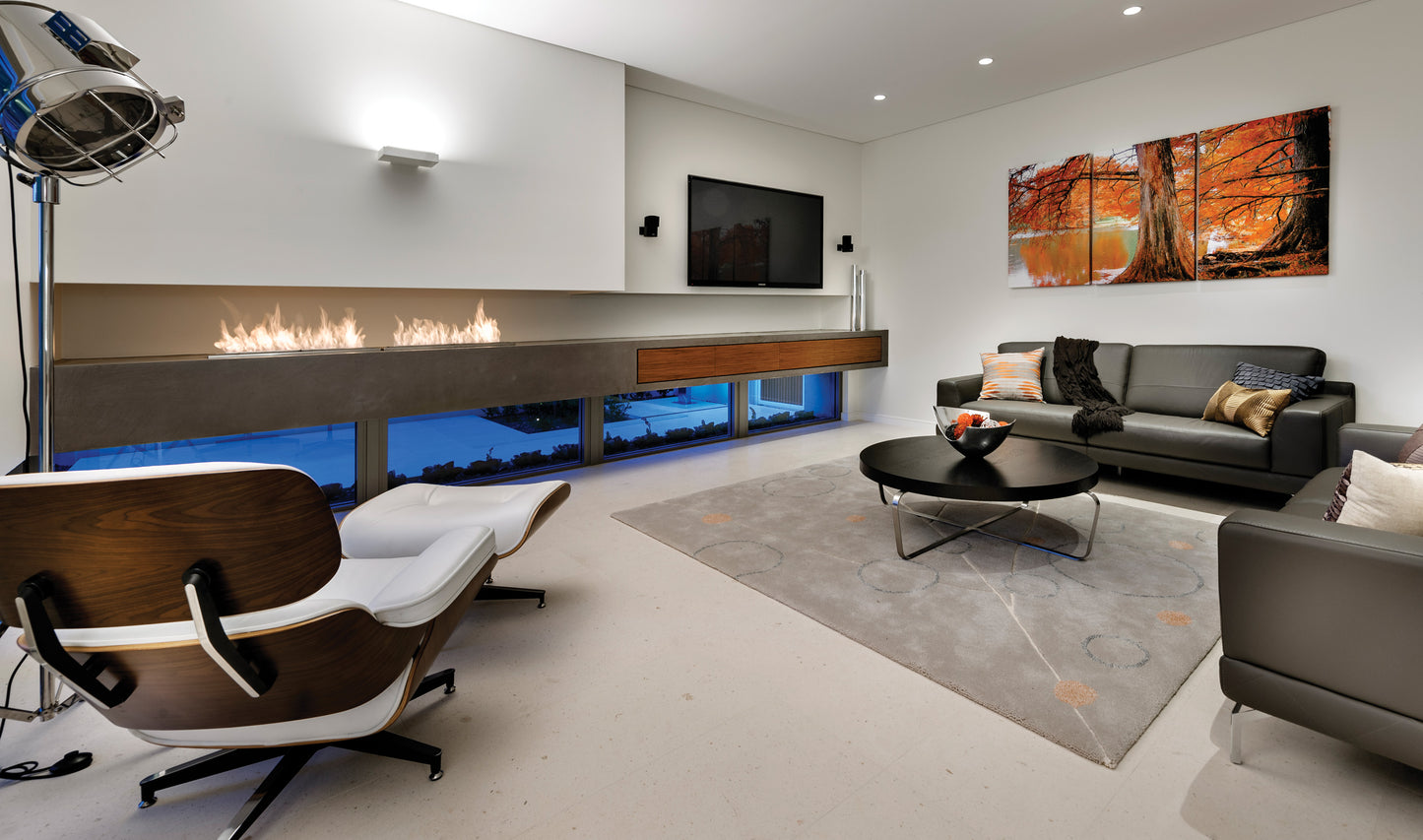 Modern living room with a fireplace, TV, and decorative wall art.