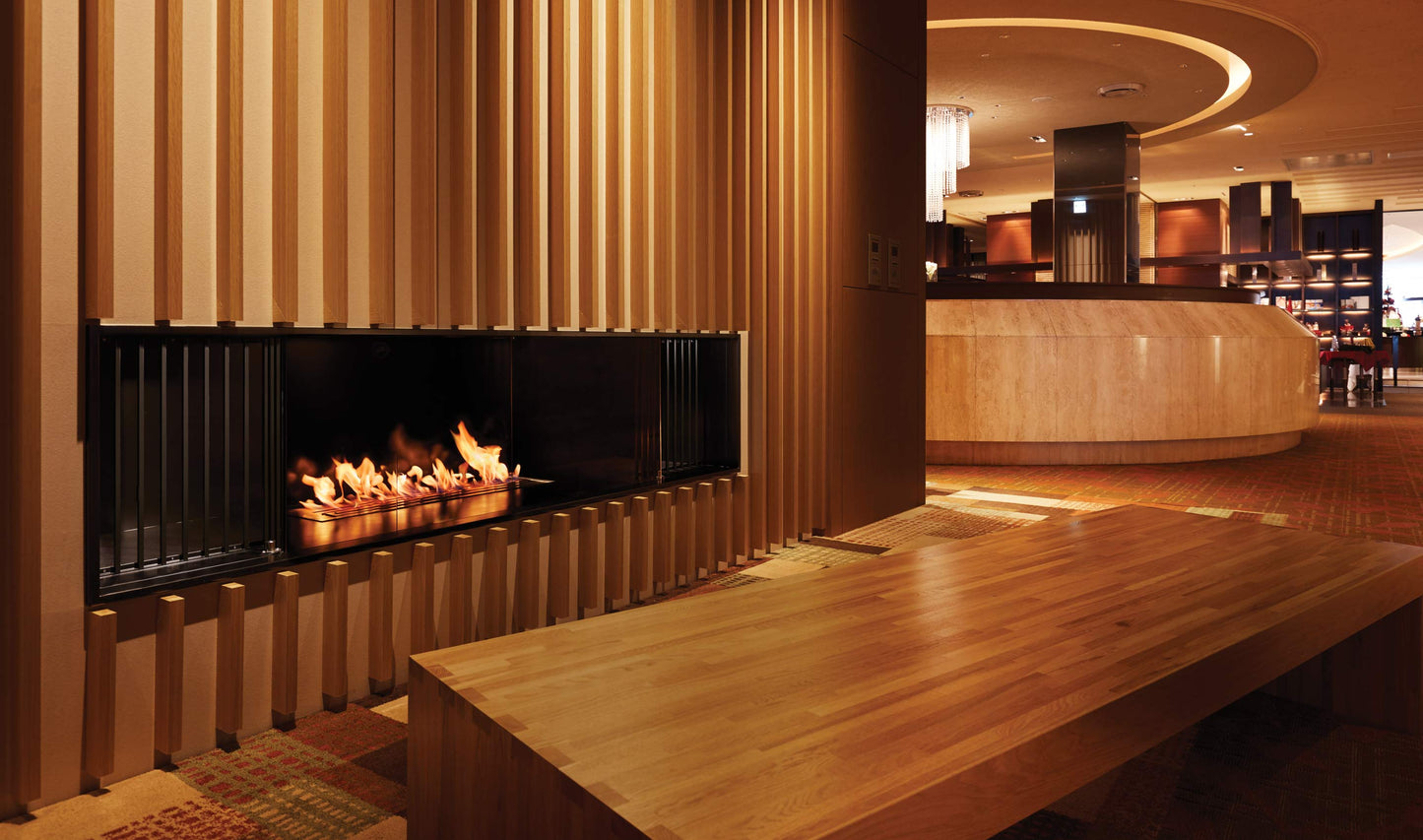 Modern fireplace in a room with wooden furniture and decor