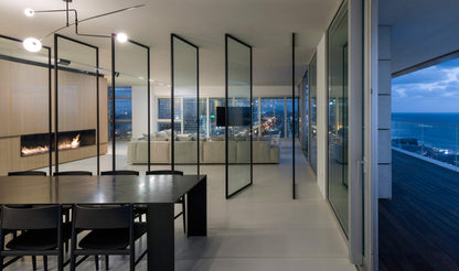 Modern interior with glass walls overlooking a scenic view
