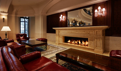 Luxurious living room with red leather furniture, a fireplace, and a television.