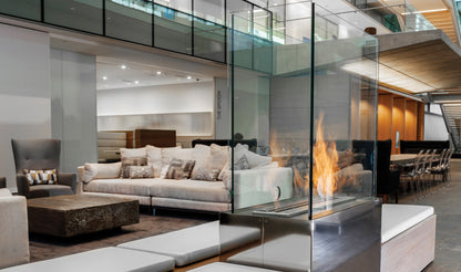 Modern living room with a glass-enclosed fireplace.
