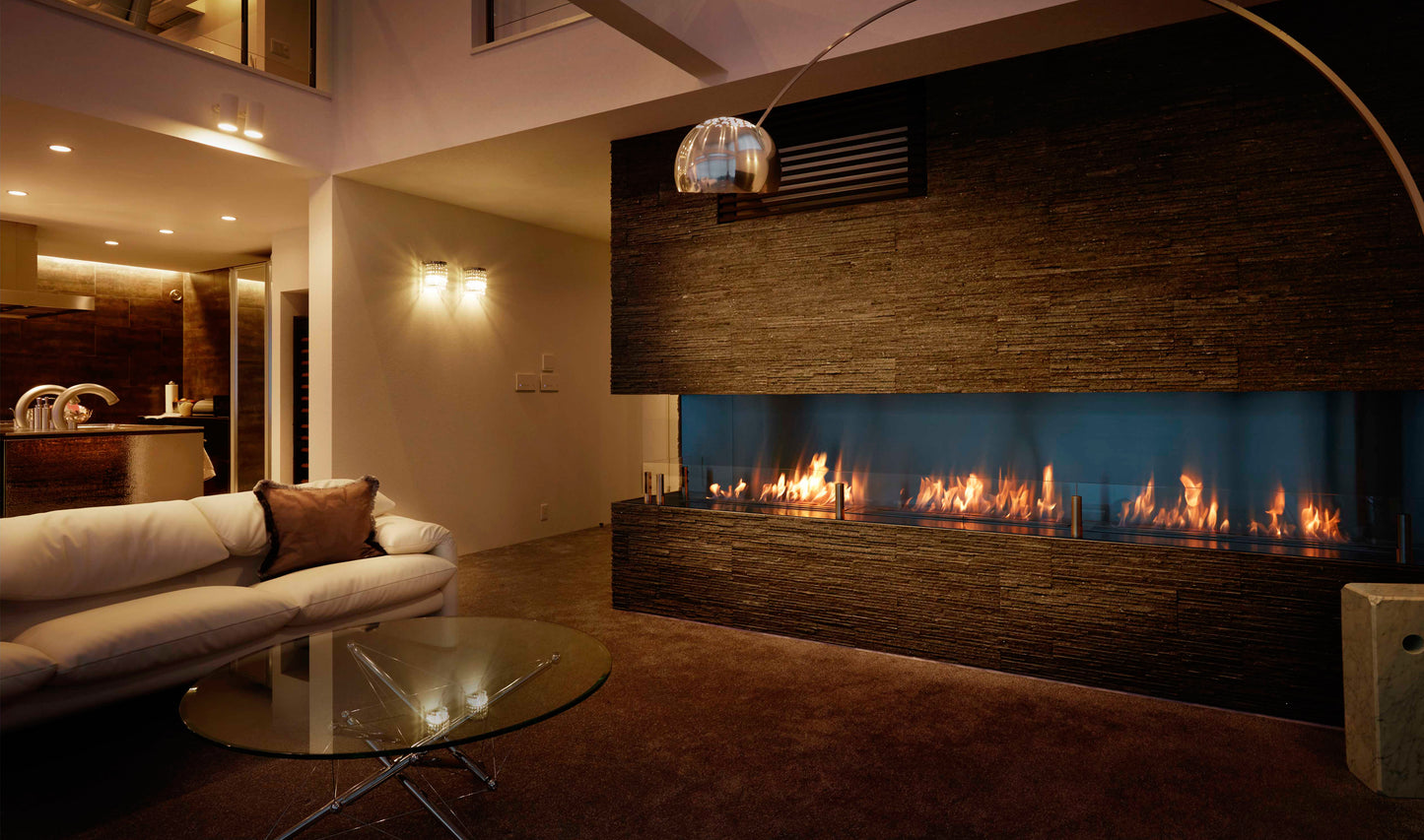 Modern living room with a large fireplace and white sofa.