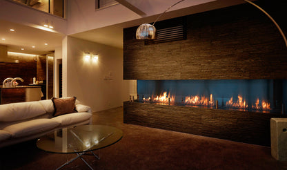 Modern living room with a large fireplace and white sofa.