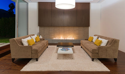 Modern living room with brown sectional sofa, coffee table, and fireplace.