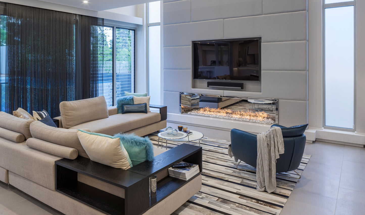 Modern living room with a fireplace, television, and comfortable seating.
