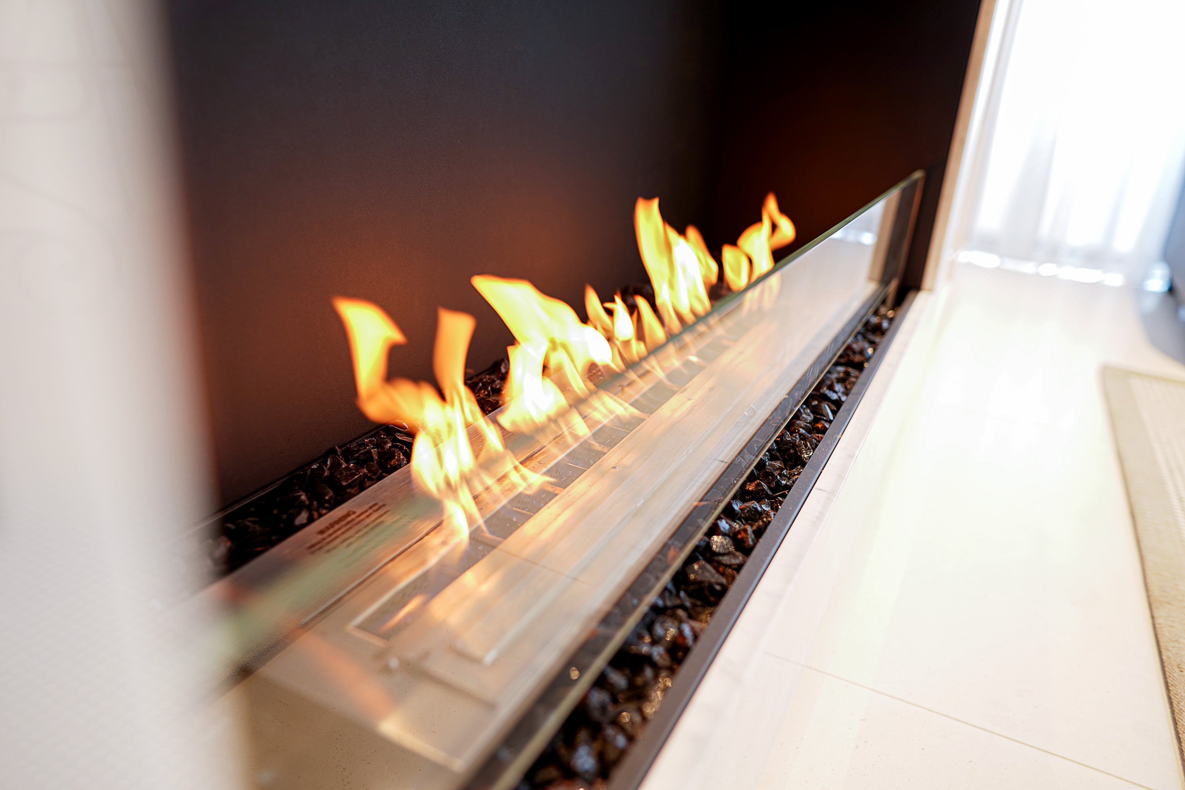 Modern electric fireplace with flames on a white floor